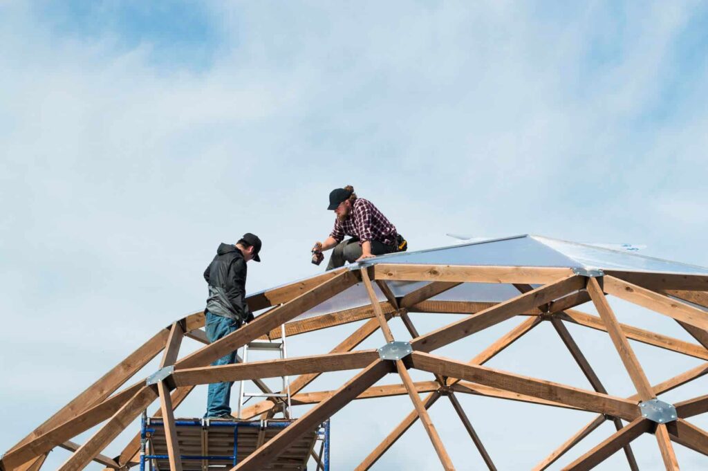 two people building dome