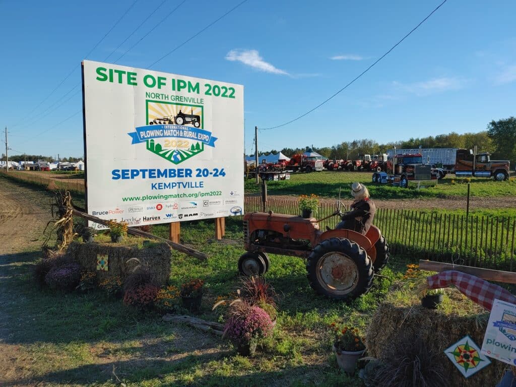 international plowing match sign with a tractor