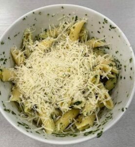 pasta with pesto and parm in a bowl