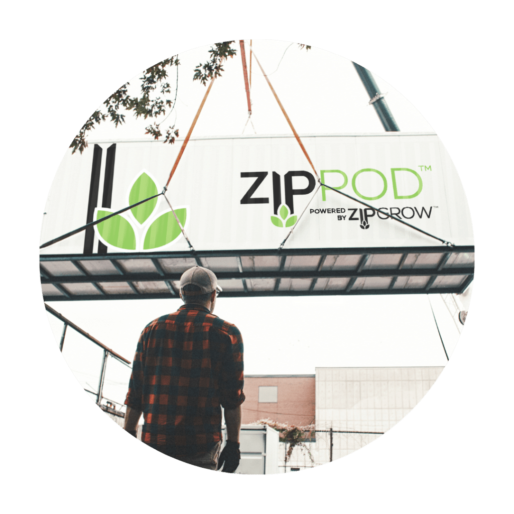 ZipPod held in the air by crane, with a man standing infront