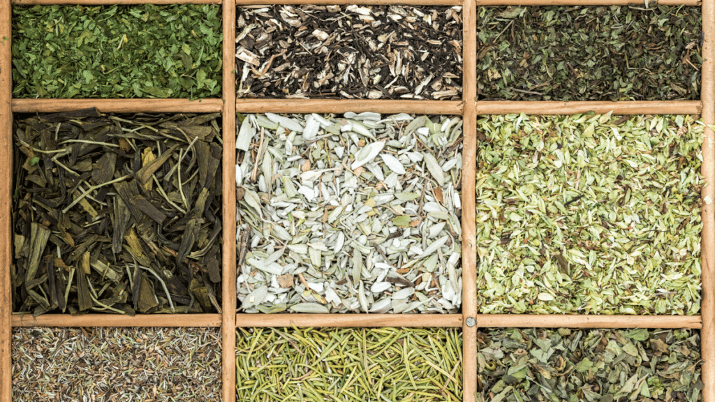 9 different dried herbs in a wooden container