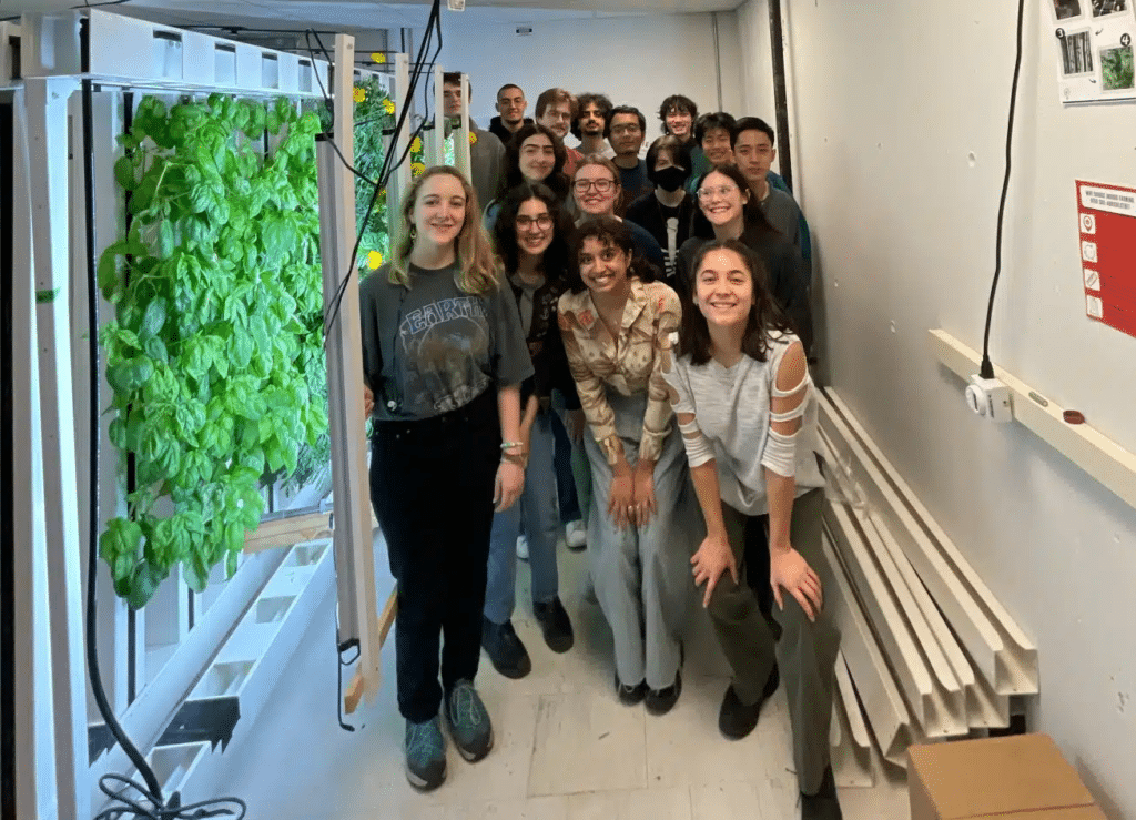 Students standing beside an education rack